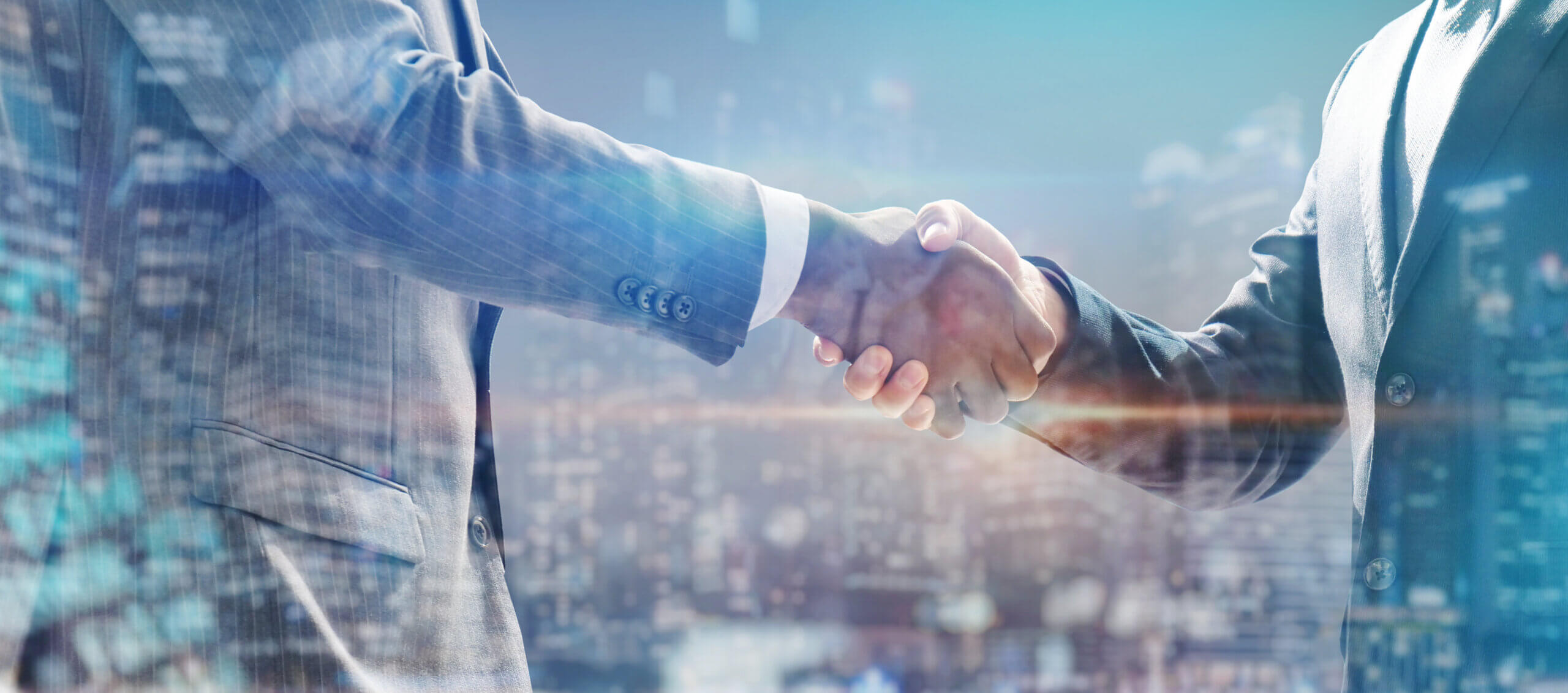 handshake of business people with skyscrapers background and finance and marketing business conclusion